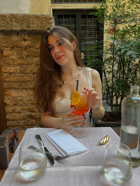 Julia enjoying a drink at an outdoor café